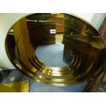 A RETRO BRASS CIRCULAR STEP FRAMED WALL MIRROR. Dia.71cms.