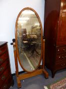 AN EARLY 20th.C.CONTINENTAL SATINBIRCH CARVED AND EBONISED OVAL CHEVAL MIRROR WITH CLUSTER COLUMN