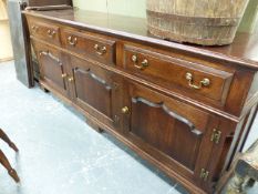 A BESPOKE GEO.III. STYLE OAK DRESSER BASE WITH THREE DRAWERS OVER SHAPED PANEL DOORS. 207 x 50 x H.