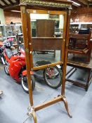 AN UNUSUAL CONTINENTAL FLOOR STANDING DRESSING MIRROR WITH GILT BRASS DECORATIONS AND CANDLE