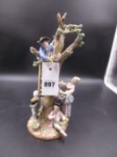 A MEISSEN GROUP OF CHILDREN HARVESTING A PEAR TREE. H.26.5cms.