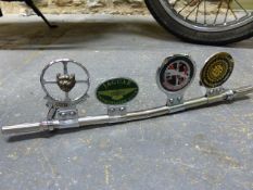 A VINTAGE CAR BADGE BAR WITH JAGUAR OWNERS CLUB AND RELATED BADGES