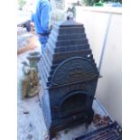 A CAST IRON ARCHITECTURAL OUTDOOR FIRE ENCLOSURE WITH STEPPED COVER. OVERALL H.125cms.