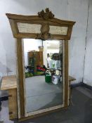 A LARGE LIMED OAK MIRROR WITH CARVED PANEL CREST. 150 x 218cms.