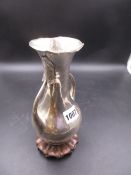 A CHINESE SILVER TWO HANDLED VASE WITH LEAF TERMINALS TO THE HANDLES BELOW THE FLARED RIM OF THE