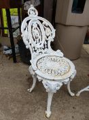 AN ANTIQUE SET OF FOUR CAST IRON GARDEN CHAIRS AND A SIMILAR CIRCULAR PATIO / GARDEN TABLE. (5)