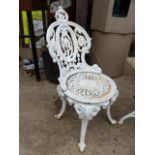 AN ANTIQUE SET OF FOUR CAST IRON GARDEN CHAIRS AND A SIMILAR CIRCULAR PATIO / GARDEN TABLE. (5)