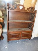 A 19th.C.COLONIAL TEAK WALL SHELVED CABINET WITH PIERCED DECORATED SIDES AND THREE SHELVES OVER
