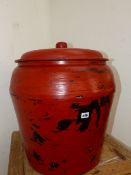 AN ORIENTAL RED LACQUERED LARGE VASE AND COVER.