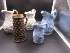 FOUR MID 19th.C. MOULDED POTTERY JUGS AND ANOTHER BY DOULTON, THE JUG, H.22.5cms. THE DOULTON WITH