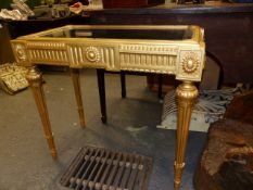 A CARVED GILTWOOD FRENCH LOUIS XVI.STYLE BIJOUTERIE TABLE WITH GLAZED LIFT TOP AND TAPERED FLUTED
