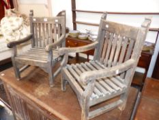 A PAIR OF GOOD QUALITY TEAK CHILD SIZE GARDEN ARMCHAIRS OF TRADITIONAL FORM, CONSTRUCTED FROM THE