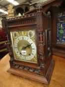 A VICTORIAN GOTHIC REVIVAL OAK CASED MANTLE CLOCK, BRASS DIAL WITH SILVERED CHAPTER RING AND