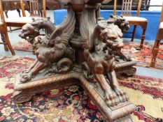 AN ANTIQUE ITALIAN CARVED AND INLAID WALNUT OCTAGONAL CENTRE TABLE WITH FOUR WINGED GRIFFIN