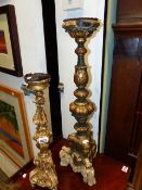TWO 17th/18th.C.ITALIANATE CARVED GILTWOOD CANDLESTICKS. LARGEST H.65cms.