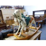 AN UNUSUAL TAXIDERMY GOAT MOUNTED ON ROCKERS WITH LEATHER SADDLE AND HARNESS. WIDTH OF FRAME