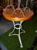 A PAIR OF ANTIQUE FRENCH IRON CAFE TABLES WITH LATER OAK TOPS. Dia.56 x H.74cms. (2)`