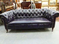 A LATE VICTORIAN LEATHER BUTTON UPHOLSTERED CHESTERFIELD SETTEE ON TURNED FORELEGS. W.199cms.