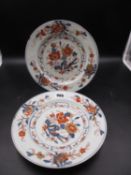 A PAIR OF CHINESE EXPORT IMARI PLATES, THE CENTRAL ROUNDELS OF PEONIES ENCLOSED BY THREE FURTHER