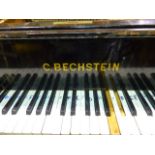 AN ANTIQUE BECHSTEIN EBONISED GRAND PIANO ON SQUARE TAPERED LEGS WITH IRON WHEELD BRACE,