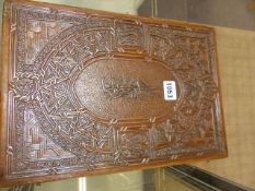 AN EASTERN CARVED SHALLOW DOCUMENT BOX, THE TOP DECORATED WITH STYLISED CALLIGRAPHY. W.36cms.