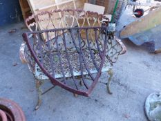 A CAST IRON SEAT OF VICTORIAN DESIGN TOGETHER WITH AN IRON HAY MANGER.