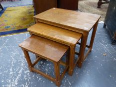 ROBERT THOMPSON, MOUSEMAN. A NEST OF THREE OCCASIONAL TABLES WITH ADZE CUT WORK TOPS AND OCTAGONAL