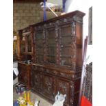 AN IMPRESSIVE VICTORIAN CARVED OAK BOOKCASE WITH FOUR DOOR GLAZED UPPER SECTION FLANKED BY FIGURES