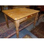 A LATE VICTORIAN PINE KITCHEN TABLE ON TURNED LEGS. 106 x 76 x H.74cms.