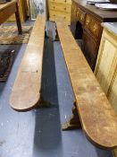 A PAIR OF LONG 19th.C.WALNUT OR FRUITWOOD FORMS / BENCHES ON TRESTLE SUPPORTS. L.314cms. (2)