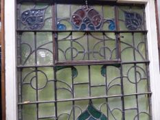 AN IMPRESSIVE ART NOUVEAU STAINED GLASS WINDOW WITH OPENING TOP CENTRE PANEL AND PAINTED WOOD FRAME.