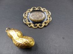 A PRECIOUS YELLOW METAL, TESTS AS GOLD, PEANUT ,MEASUREMENTS 4.5cms, WEIGHT 16.6grms. TOGETHER