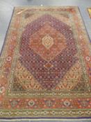 A PERSIAN TABRIZ CARPET. 196 x 294cms.