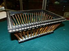 A 19th.C.INDIAN EBONY AND PORCUPINE QUILL BASKET, THE RECTANGULAR BASE PICQUE WITH A SIX PETALLED