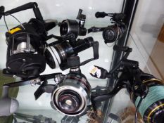 TWO SHAKESPEARE FISHING REELS, TWO ABU REELS, A DAIWA REEL, BAIT RUNNER REEL AND A WYCHWOOD SOLACE