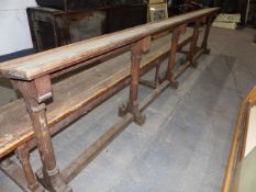 A VICTORIAN GOTHIC OAK ALTAR RAIL WITH SLANTED PRAYER BOOK TOP. L.340cms.