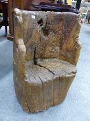 AN EARLY CARVED RUSTIC TRUNK FORM SEAT OF DUG OUT FORM. W.56 x H.67cms.