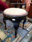 AN ART DECO EBONISED ROUND STOOL WITH GILT DECORATION, POSSIBLY AUSTRIAN.