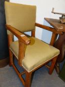 A PAIR OF 19th.C.PUGINESQUE OAK ARMCHAIRS ON CHAMFERED SQUARE SUPPORTS AND STRETCHERS. (2)