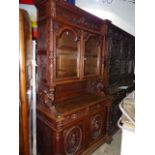 AN ANTIQUE FRENCH CARVED OAK BOOKCASE CABINET WITH GLAZED UPPER OVER TWO DRAWERS AND TWO DOORS