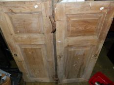 TWO PAIRS OF ANTIQUE PINE PANELLED CUPBOARD DOORS OF DIFFERING DESIGN.