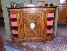 A VICTORIAN WALNUT CREDENZA, CENTRAL PANEL DOOR WITH PORCELAIN PLAQUE FLANKED BY BOW FRONT SIDED