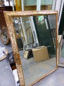AN ANTIQUE CONTINENTAL POLYCHROME AND GILT FRAME NOW MOUNTED AS A BEVELLED EDGE MIRROR. 84 x