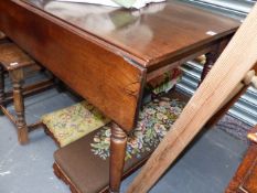 A LARGE 19th.C.MAHOGANY DROP LEAF TABLE ON RING TURNED LEGS AND CASTORS. L.158 x H.77cms.