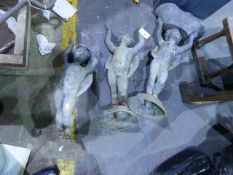 A SET OF THREE CAST LEAD GARDEN FIGURES OF CHERUBS WITH ARMS ALOFT, TWO SUPPPORTING BASKETS.