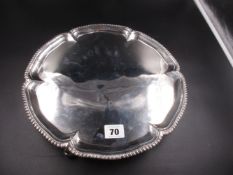 A GEORGE III SILVER SALVER, FEATURING A GADROONED RIM, AND STANDING ON THREE HOOF FEET. DATED 1766