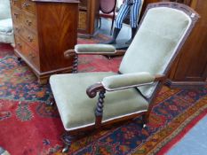 A 19th.C.OAK SHOW FRAME LOW LIBRARY ARMCHAIR ON TURNED LEGS WITH BRASS CASTORS.