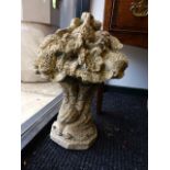 A PAIR OF WEATHERED CARVED STONE CORNUCOPIA FORM FINIALS WITH FLOWER HEAD TOPS. H.50cms.