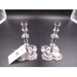 A PAIR OF SILVER HALLMARKED GEORGIAN STYLE CANDLESTICKS, DATED 1934 FOR GARRARD & CO, LONDON. H.