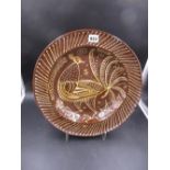 A POTTERY SLIPWARE PLATE WITH BIRD DECORATION. Dia.38cms.